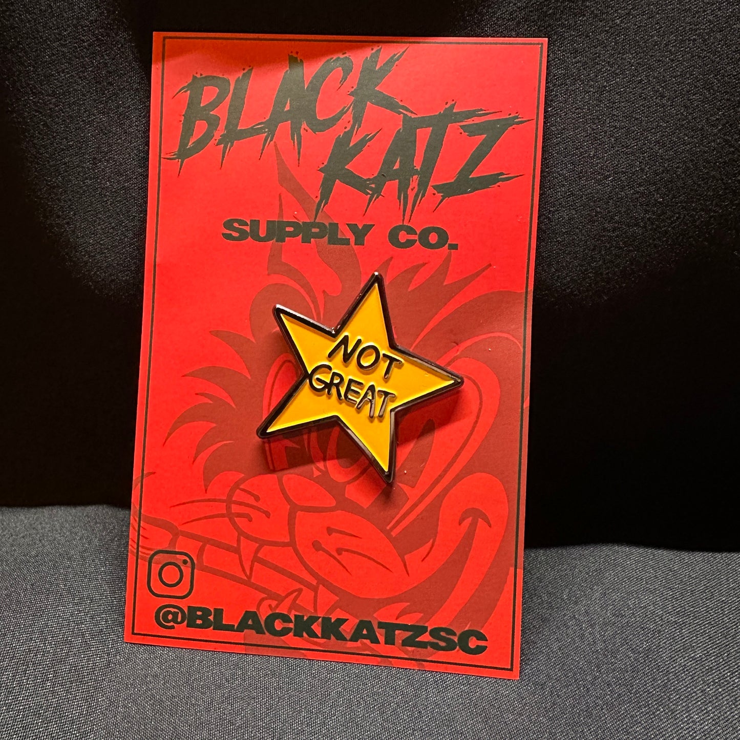 Not Great enamel pin front view, 1.5 inches, soft enamel, red backing card
